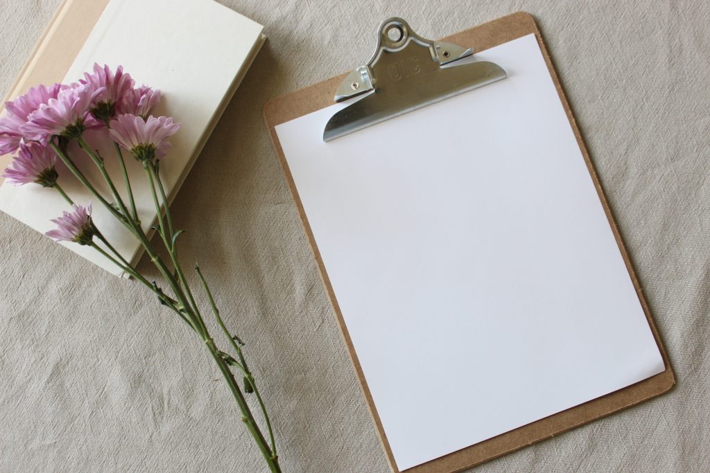 bouquet of flowers next to clipboard